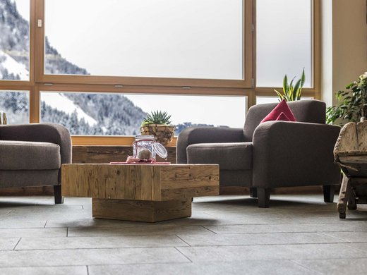 Family hotel in Pflersch: inclusive services Cozy seating area with snowy mountain view through large window