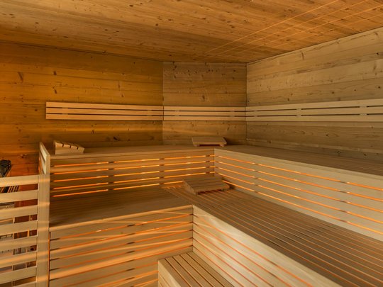 Hotel in Pflerschtal: Aktivhotel Panorama Interior of a modern wooden sauna with illuminated benches