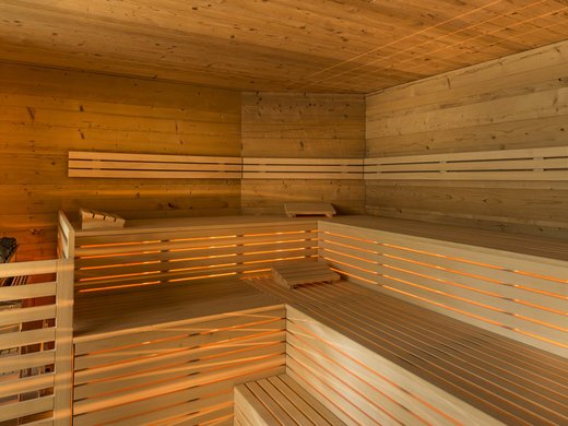 Ski touring in Pflerschtal Interior of a modern wooden sauna with illuminated benches