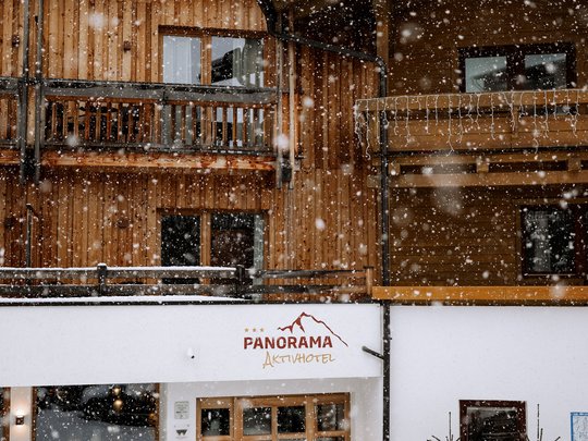 Family hotel vicino a Vipiteno: “hallo” e benvenuti! Neve davanti a edificio in legno con ingresso Panorama Aktivhotel